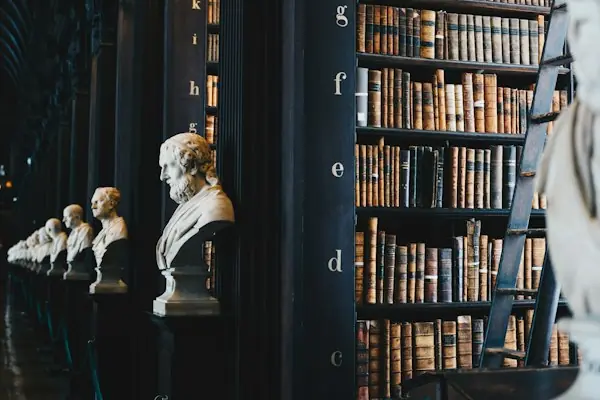 Law library shelves with marble busts, representing the Medicare claim appeals process from redetermination to federal court