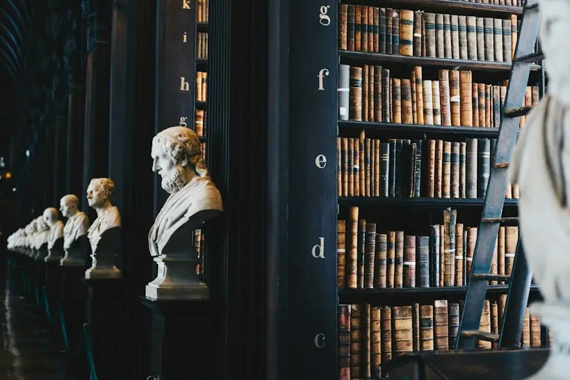 Law library shelves with marble busts, representing the Medicare claim appeals process from redetermination to federal court