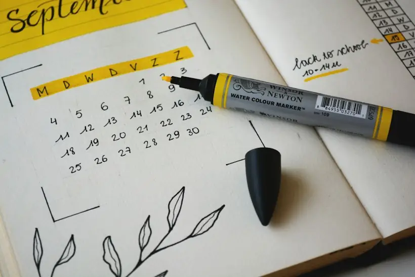 Open notebook with a hand-drawn monthly calendar and highlighter, representing claim filing deadlines and timely filing limits