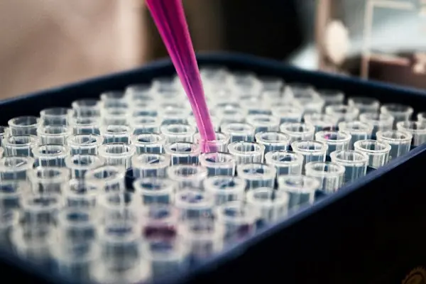 Laboratory technician processing molecular genetic testing for genetic testing billing 2026