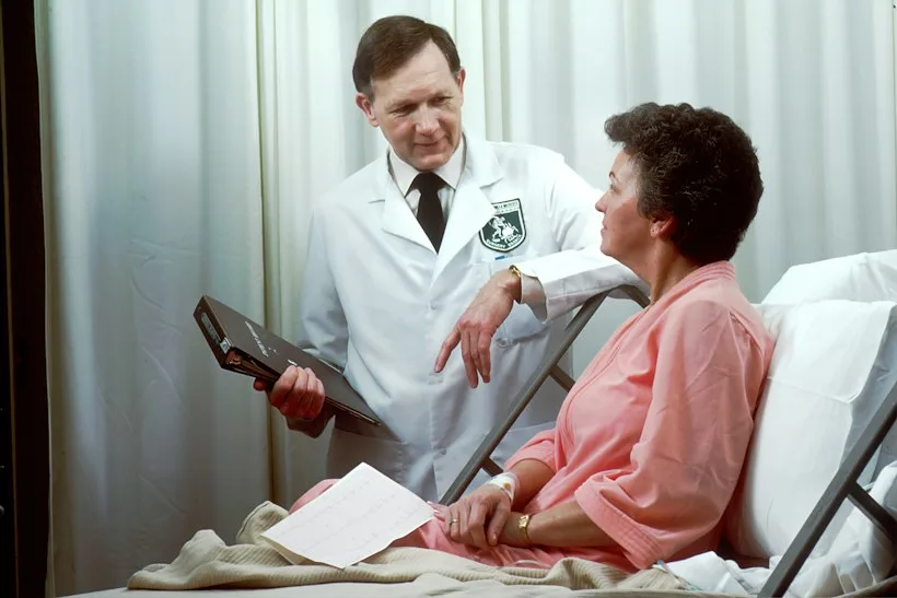 Physician sitting across from a patient during an unhurried office consultation, representing a concierge medicine retainer visit