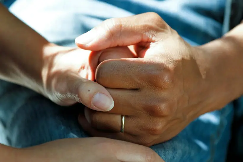 Two hands clasped in a supportive gesture, representing psychological and neuropsychological testing services