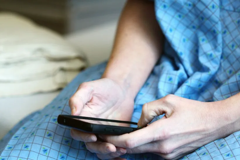 Care coordinator on a phone call reviewing a patient's chart, representing Principal Care Management time tracking